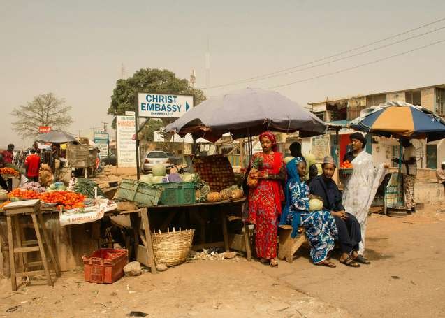 Traders at a Nairobi roadside market under printed umbrellas